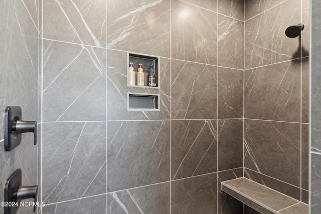 bathroom with a tile shower