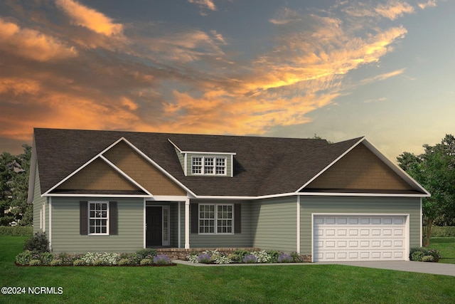 view of front of house with a garage and a lawn