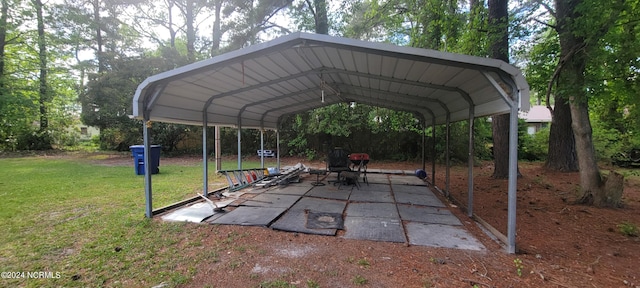 view of car parking with a lawn and a carport