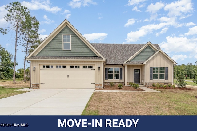 craftsman-style home featuring a garage and a front yard