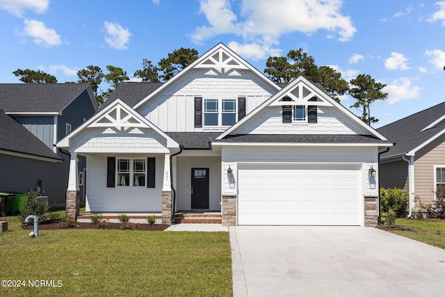 craftsman house with a garage and a front yard