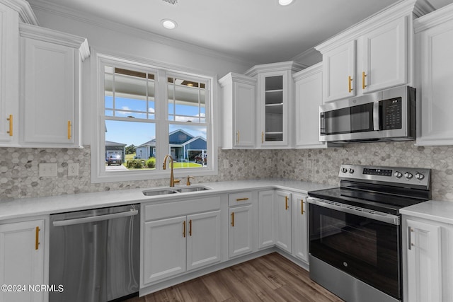 kitchen with decorative backsplash, white cabinetry, appliances with stainless steel finishes, and sink