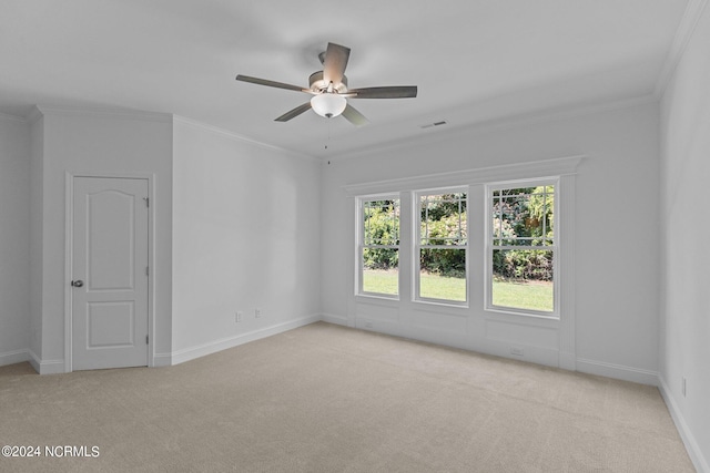 empty room with light carpet, ceiling fan, and ornamental molding