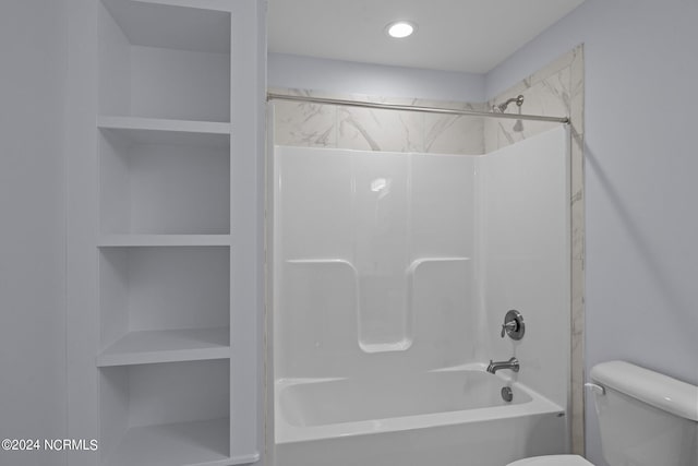 bathroom with bathtub / shower combination and toilet