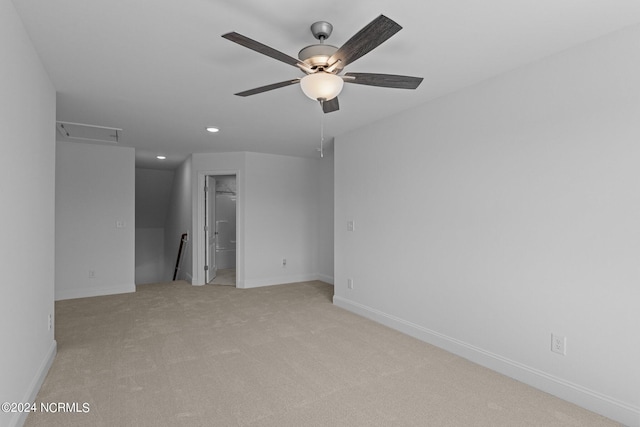 unfurnished bedroom featuring light carpet, ceiling fan, and connected bathroom