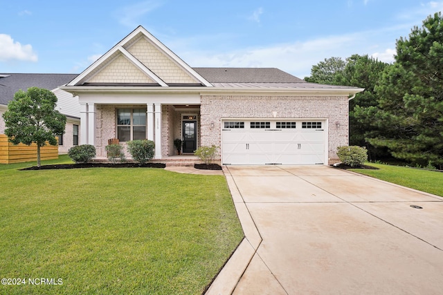 view of front of house featuring a garage and a front lawn