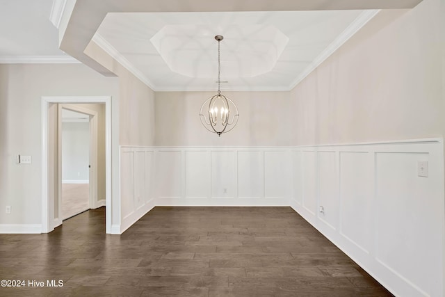 unfurnished dining area featuring dark hardwood / wood-style flooring, a tray ceiling, ornamental molding, and a notable chandelier