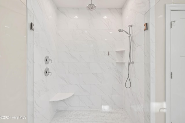 bathroom with a shower with door