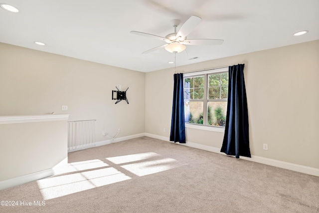 carpeted empty room featuring ceiling fan