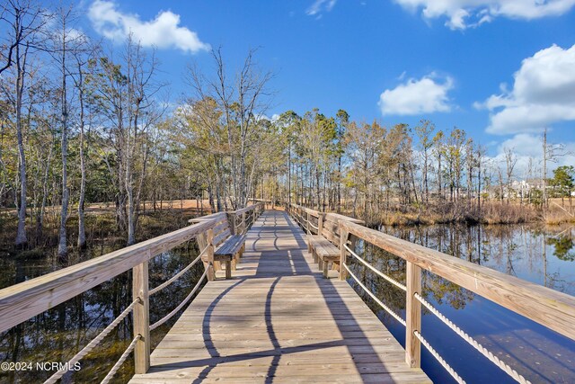 view of patio with a water view and a fire pit