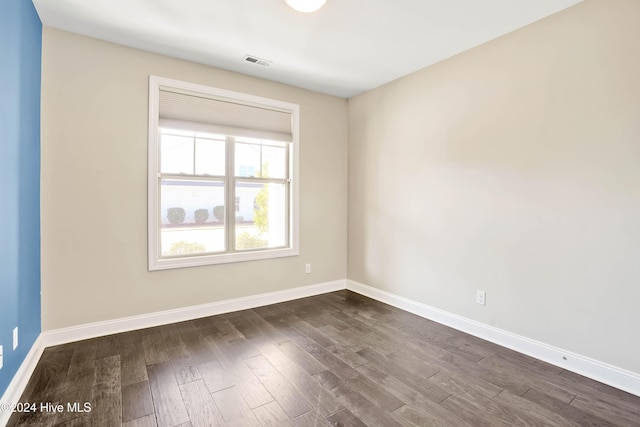 unfurnished room with dark hardwood / wood-style floors