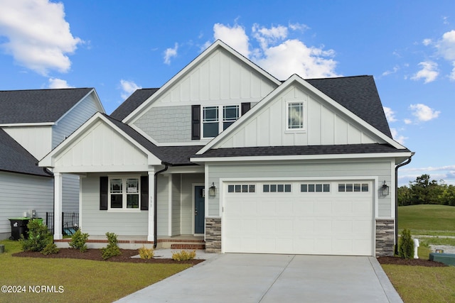 craftsman inspired home featuring a front yard and a garage