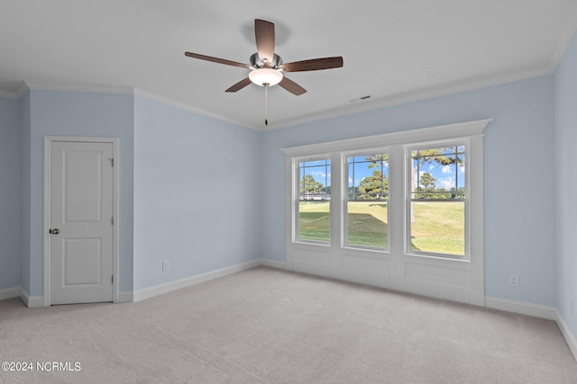 unfurnished room with light colored carpet, ceiling fan, and crown molding