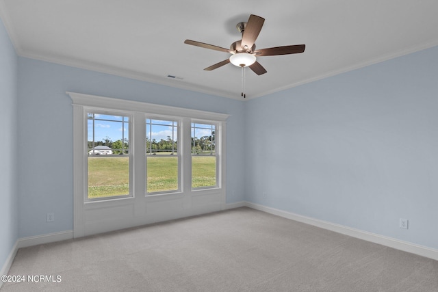 unfurnished room featuring light colored carpet, ceiling fan, and ornamental molding