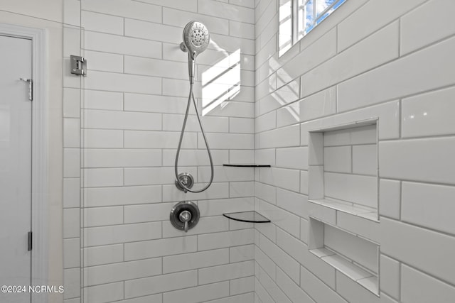 bathroom with a tile shower