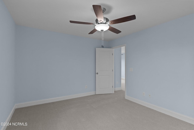 unfurnished room with light colored carpet and ceiling fan