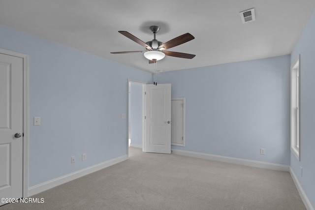 unfurnished room featuring light carpet and ceiling fan