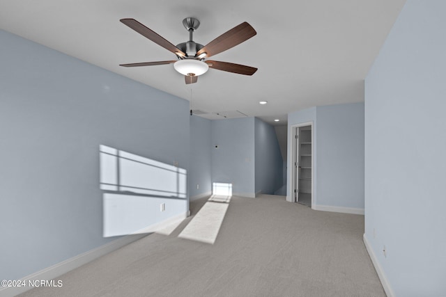 spare room with ceiling fan and light colored carpet