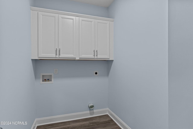 clothes washing area featuring hookup for a washing machine, cabinets, dark hardwood / wood-style floors, and hookup for an electric dryer