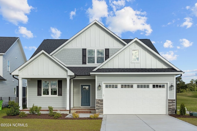 craftsman-style home with a front lawn and a garage