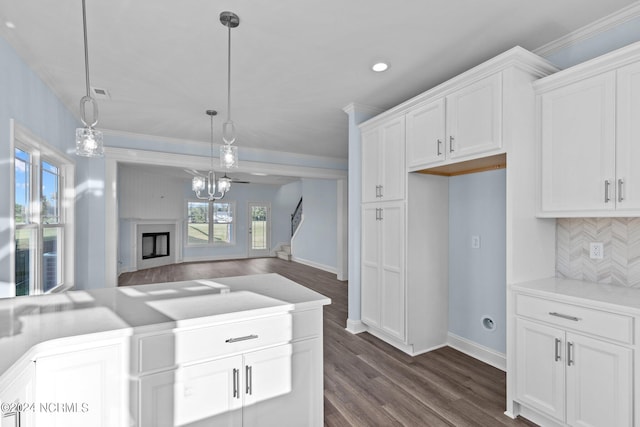 kitchen featuring decorative backsplash, pendant lighting, white cabinetry, and dark wood-type flooring