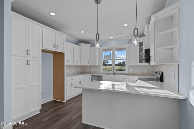 kitchen featuring white cabinets, pendant lighting, and appliances with stainless steel finishes