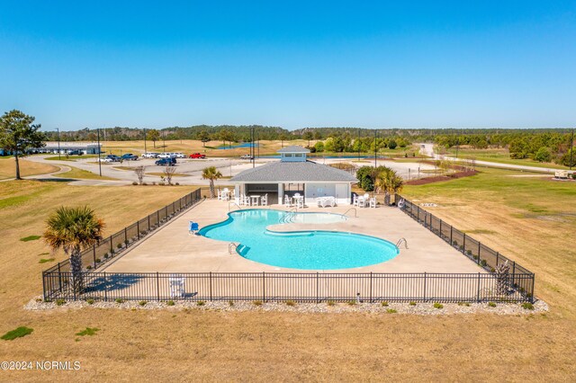 view of swimming pool featuring a yard and a patio