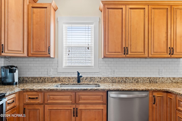 kitchen with backsplash, dishwasher, sink, and light stone counters