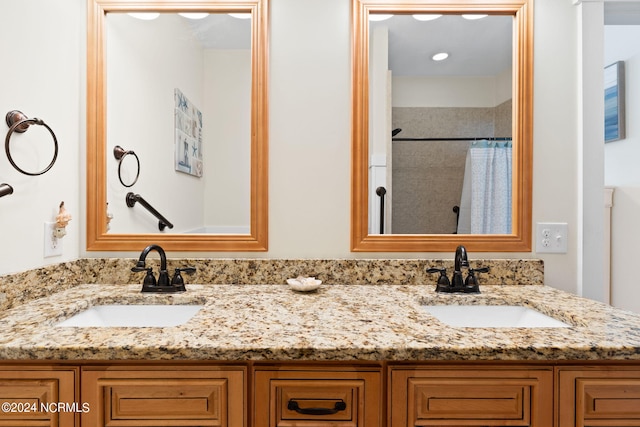 bathroom with dual sinks and oversized vanity