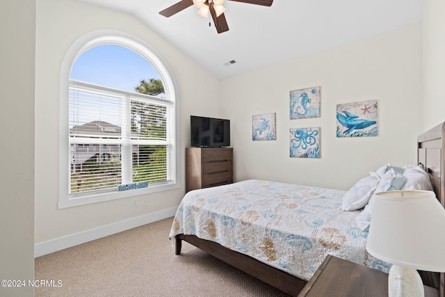 carpeted bedroom with lofted ceiling, multiple windows, and ceiling fan