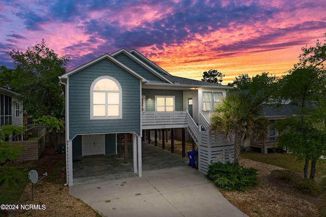 raised beach house featuring a carport