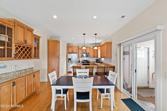 dining area with light wood-type flooring