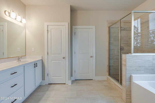 bathroom featuring vanity with extensive cabinet space, shower with separate bathtub, and tile flooring