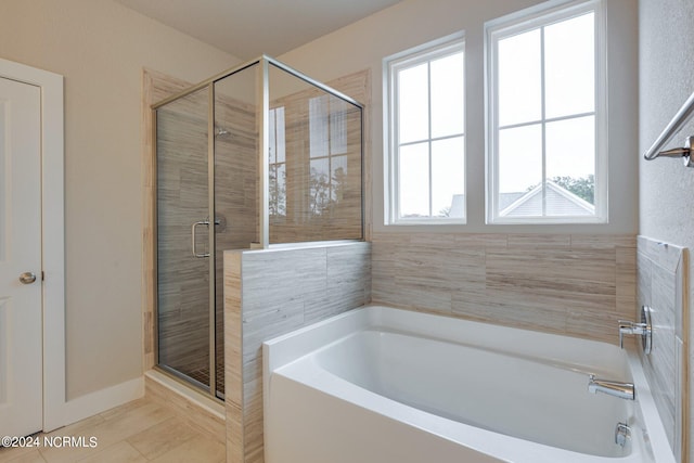 bathroom featuring tile flooring and plus walk in shower