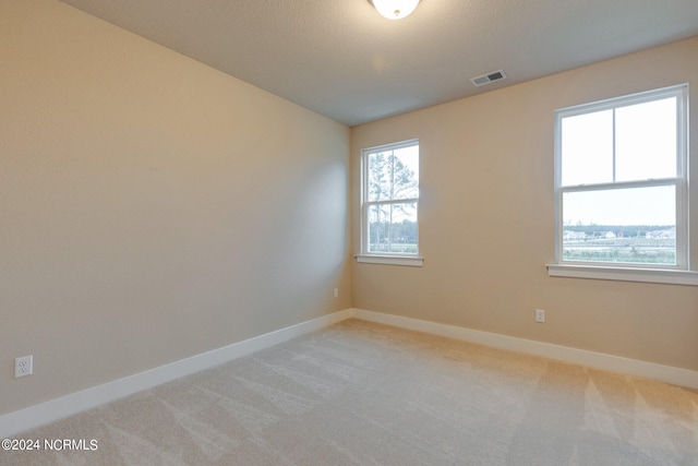 unfurnished room featuring carpet flooring