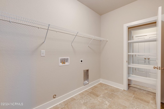 washroom featuring hookup for an electric dryer, light tile floors, and hookup for a washing machine