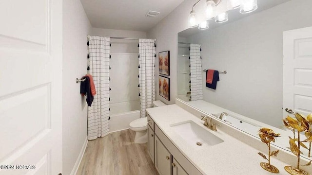 full bathroom with toilet, shower / bath combo with shower curtain, vanity, and hardwood / wood-style floors