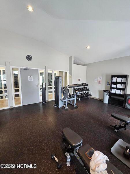 workout area with high vaulted ceiling