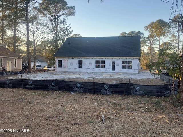 view of back house at dusk