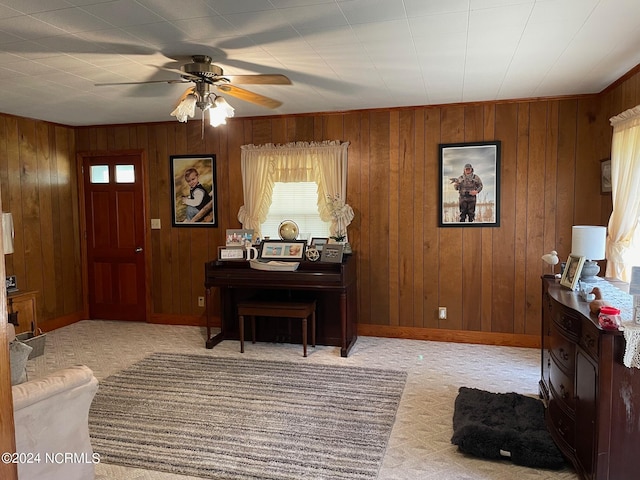 miscellaneous room with wood walls, carpet, and ceiling fan