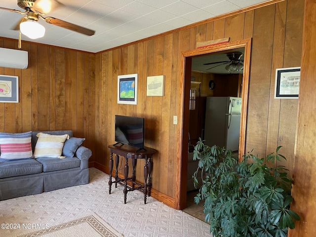 living room with ceiling fan, wooden walls, and a wall mounted AC