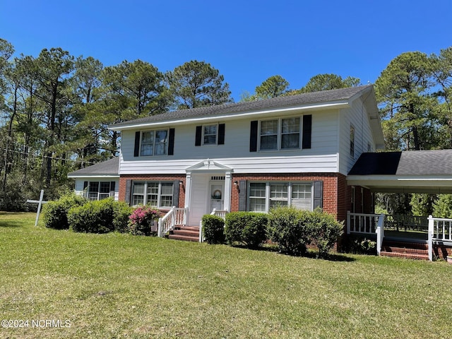 view of front facade with a carport and a front lawn