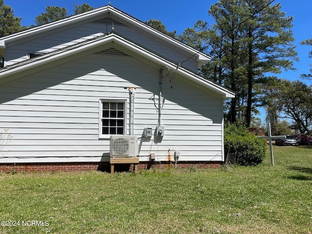 view of side of home featuring a yard