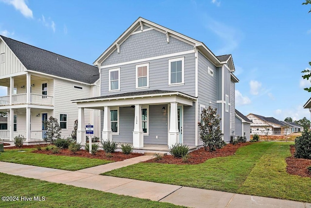 view of front of property featuring a front lawn and covered porch