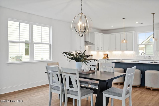 1134 Trisail Ter, Wilmington, NC 28412 - dining space with light wood finished floors, a chandelier, and baseboards