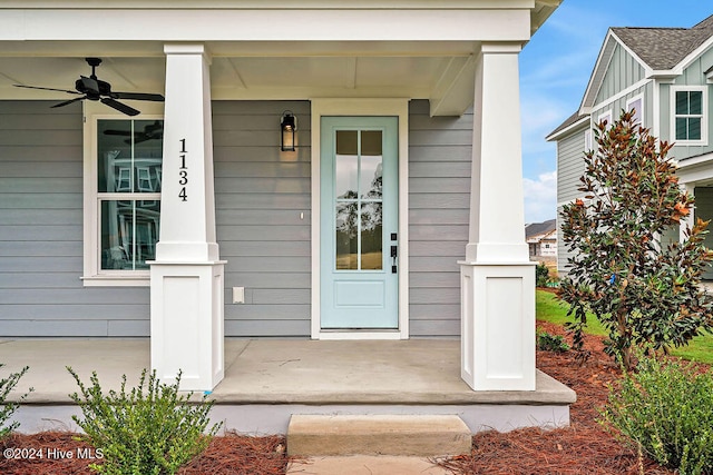 doorway to property with ceiling fan and covered porch