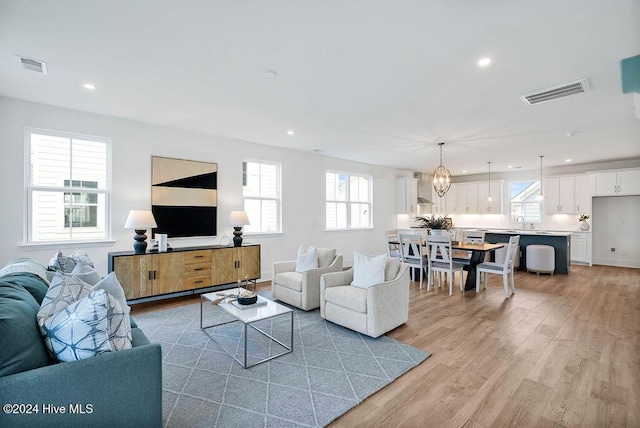 1134 Trisail Ter, Wilmington, NC 28412 - living room with light wood-style floors, recessed lighting, and a chandelier