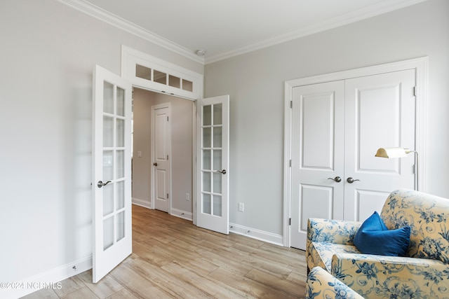 living area with french doors, ornamental molding, and light wood-type flooring