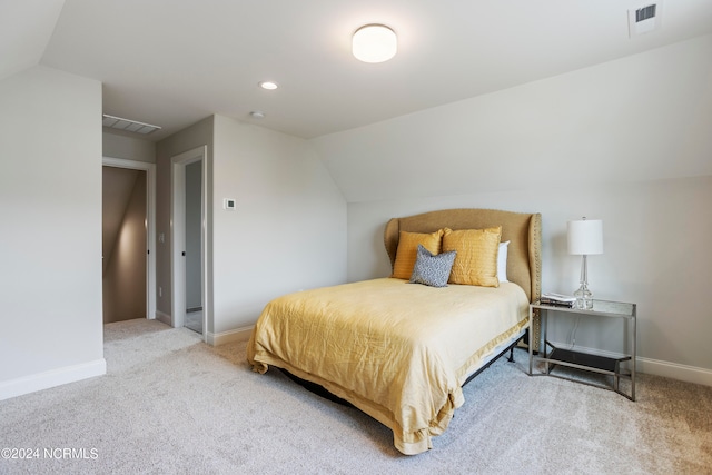 carpeted bedroom with vaulted ceiling