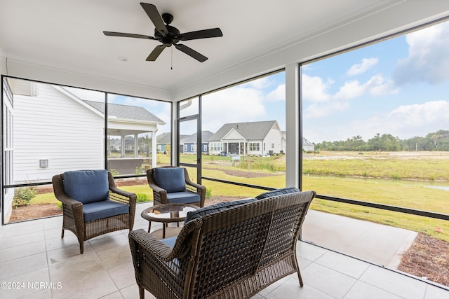 sunroom featuring ceiling fan